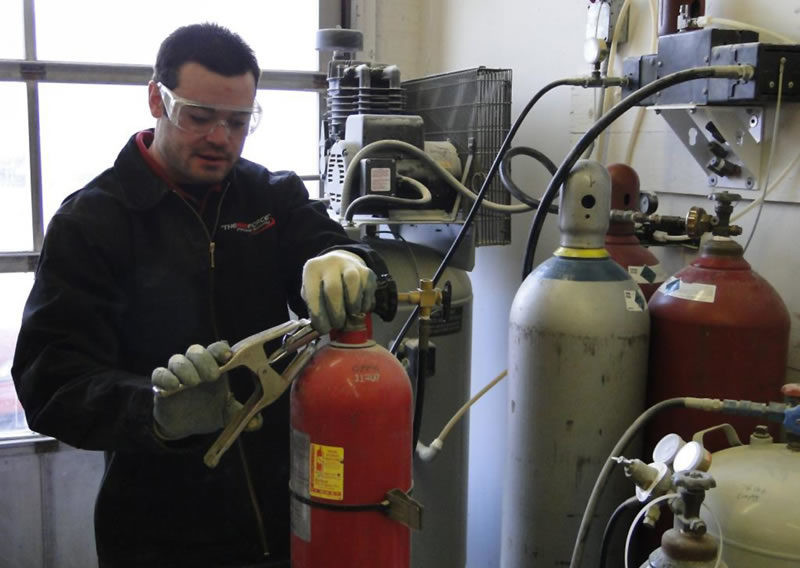 Technician working on fire extinguiser